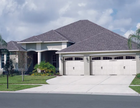 White vertical short panel  garage door with arch stockton windows and decorative hardware