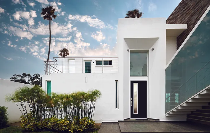 Black modern entry door with 1 vertical lite on a coastal home.