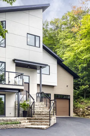 Large modern home with hardie plank and panel in Artic White and Khaki Brown