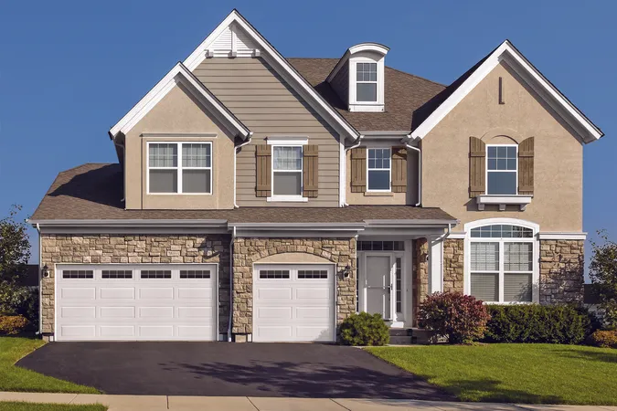 White Ranch Panel residential garage door with Stockton windows