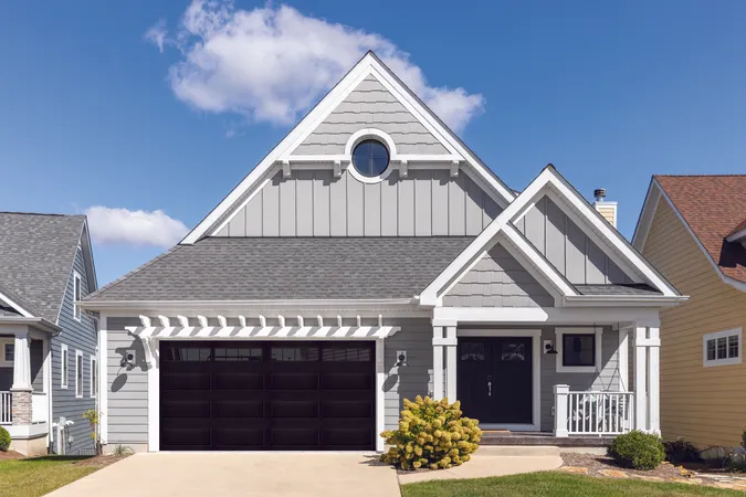 Black residential steel garage door with Stockton windows