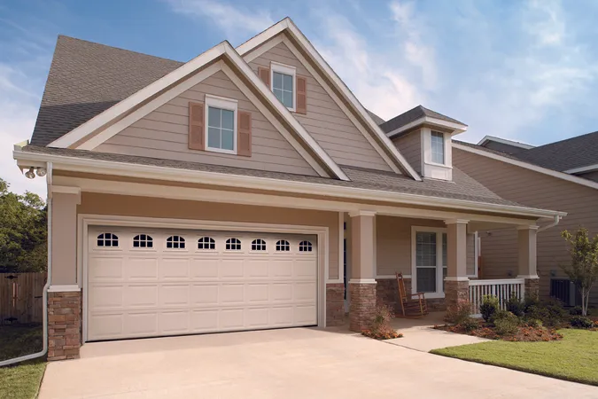 White colonial panel garage doors with cascade windows
